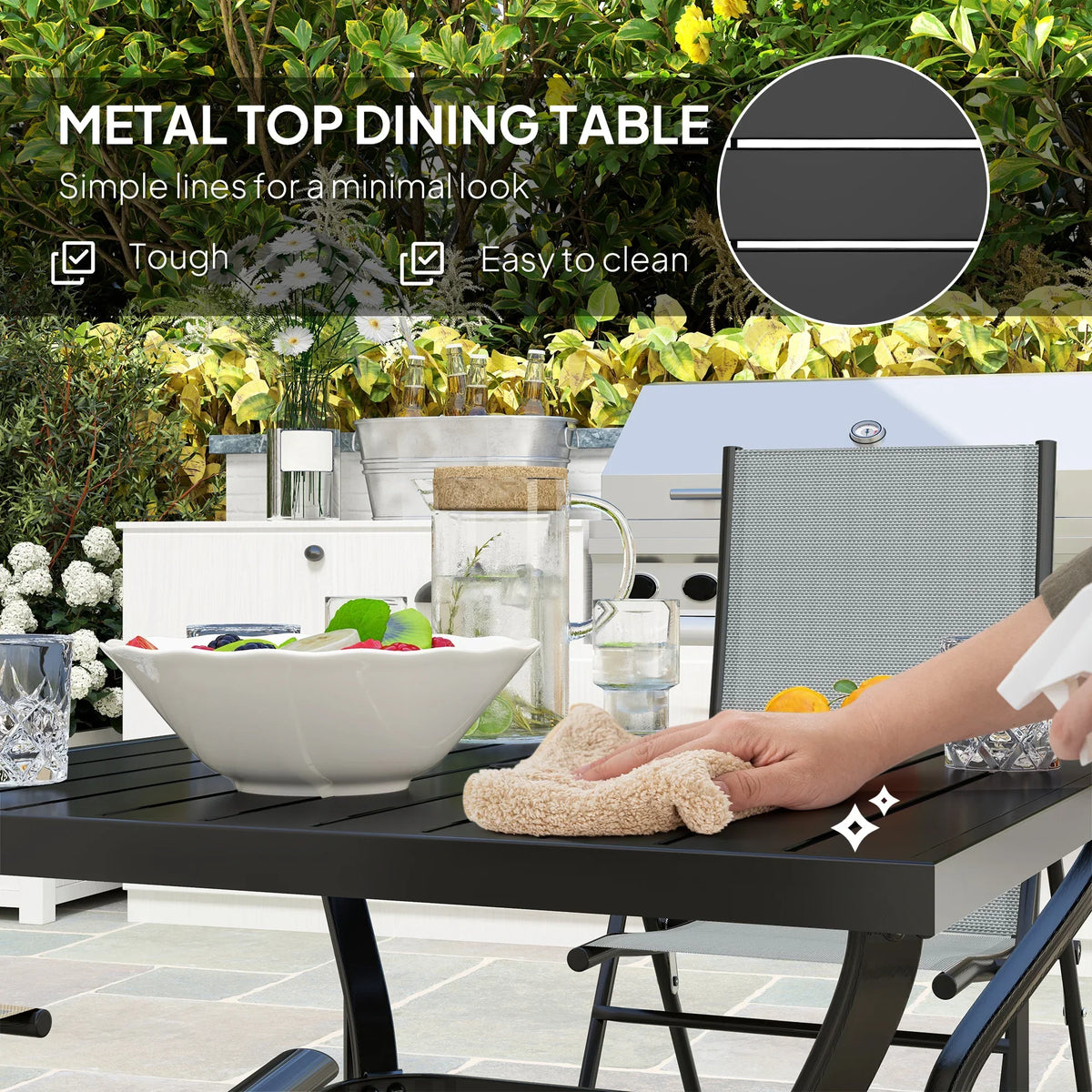 Black metal patio dining table with grey mesh chairs; hand wiping the tabletop