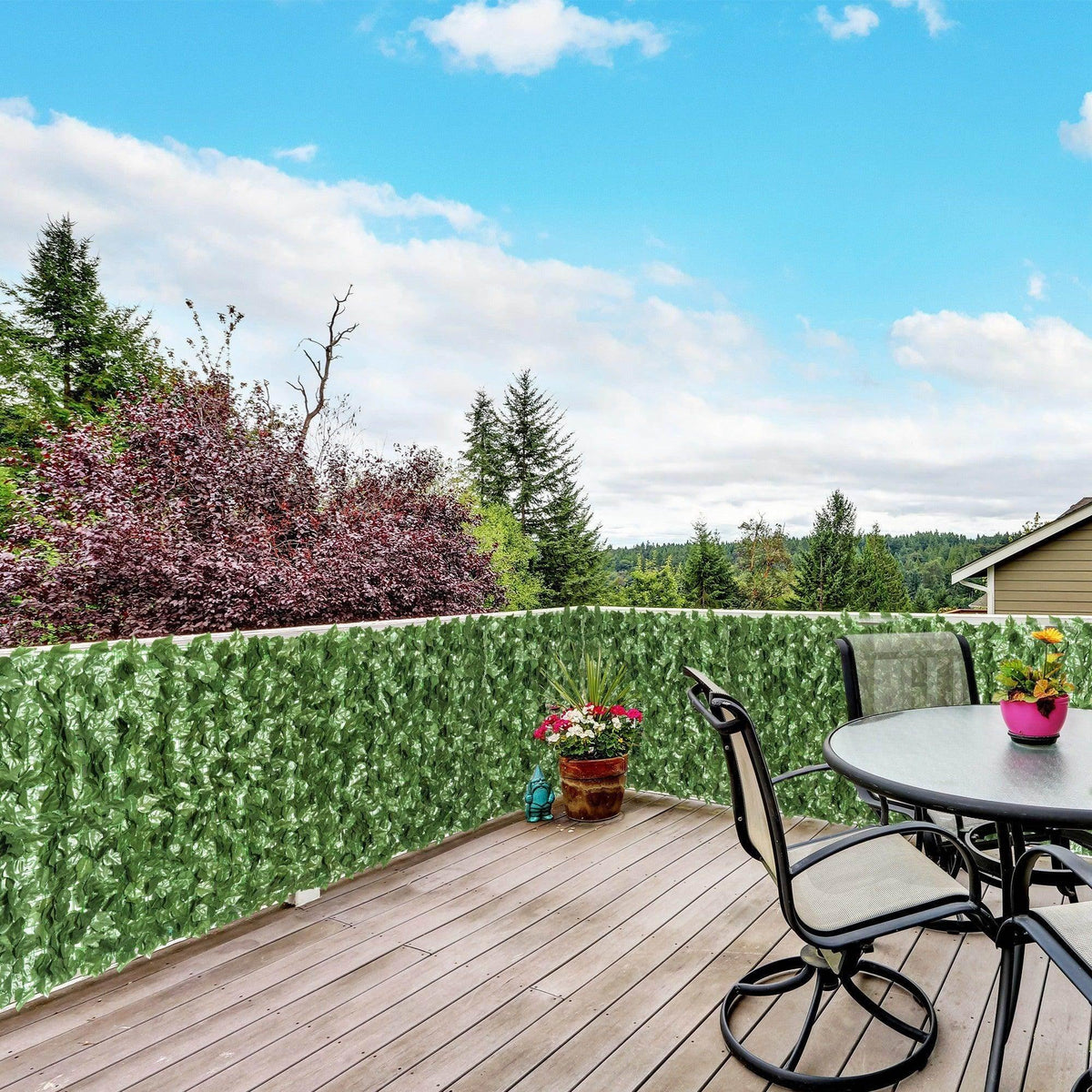 Dark green artificial leaf hedge privacy fence panel with dense leafy texture for patio