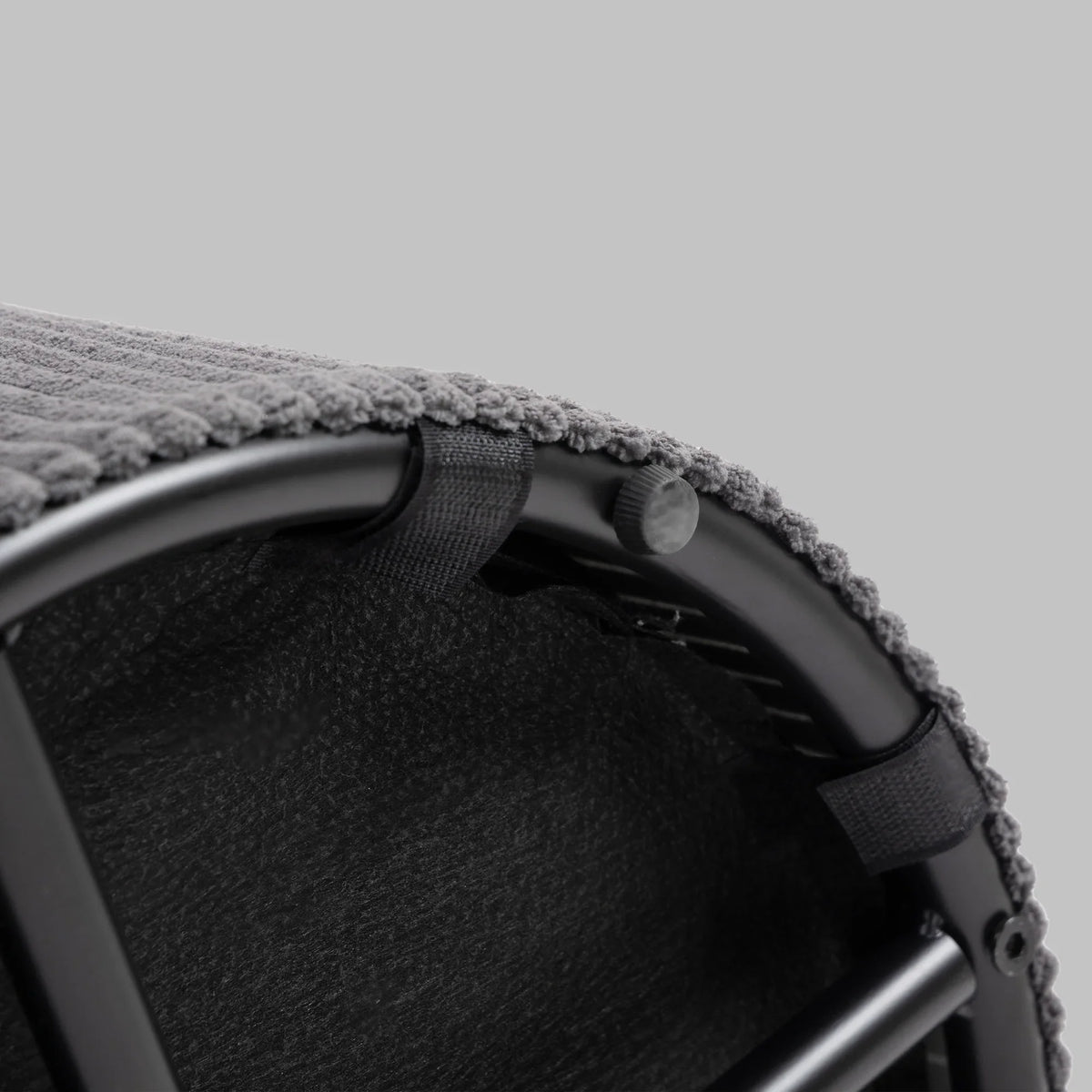 Close-up of corduroy storage ottoman lid opening with carry handle