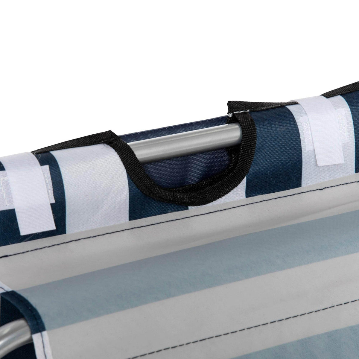 Beach chair armrest with navy-blue fabric strap over silver metal frame