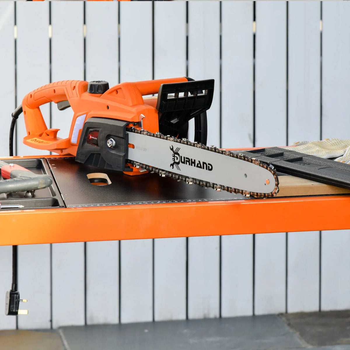 Orange corded electric chainsaw with black guide bar and chain, Durhand