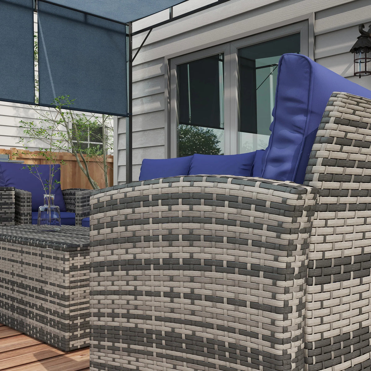 Corner rattan outdoor sofa with navy cushion seat and tall rounded backrest