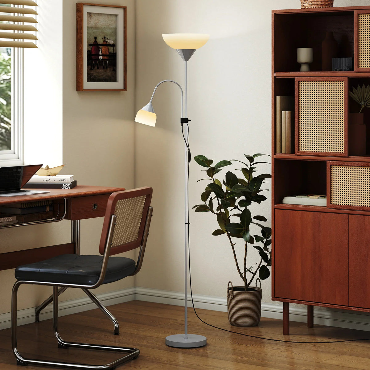 Silver LED floor lamp with two white shades and adjustable gooseneck beside a plant