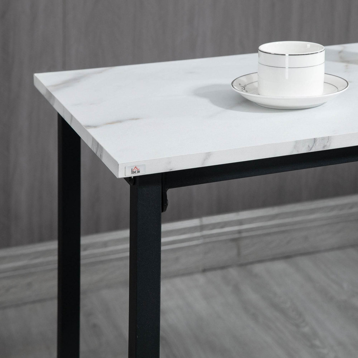 Close-up of white marble-effect bar table top with black metal legs