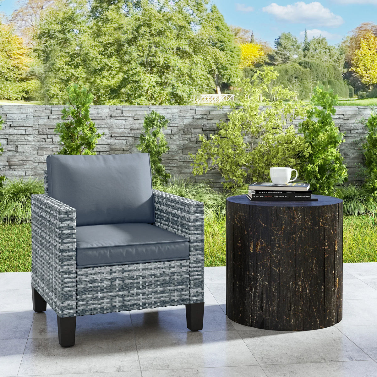 Light grey woven rattan armchair with blue seat and back cushions, four dark legs