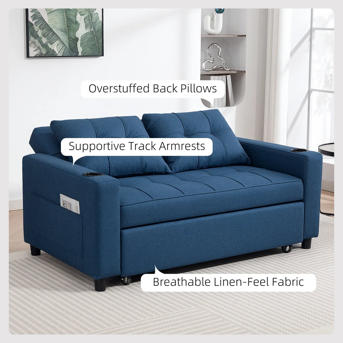 Dark blue sofa bed with track armrests, overstuffed back pillows, side view