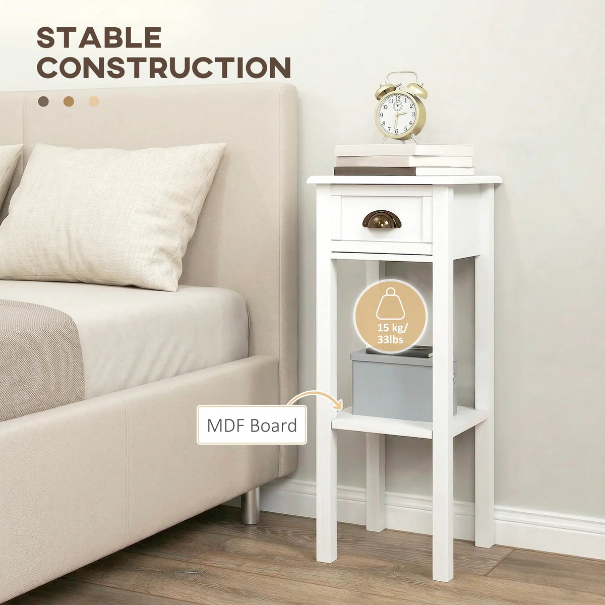 White bedside table with drawer and open shelf, stable frame beside a couch