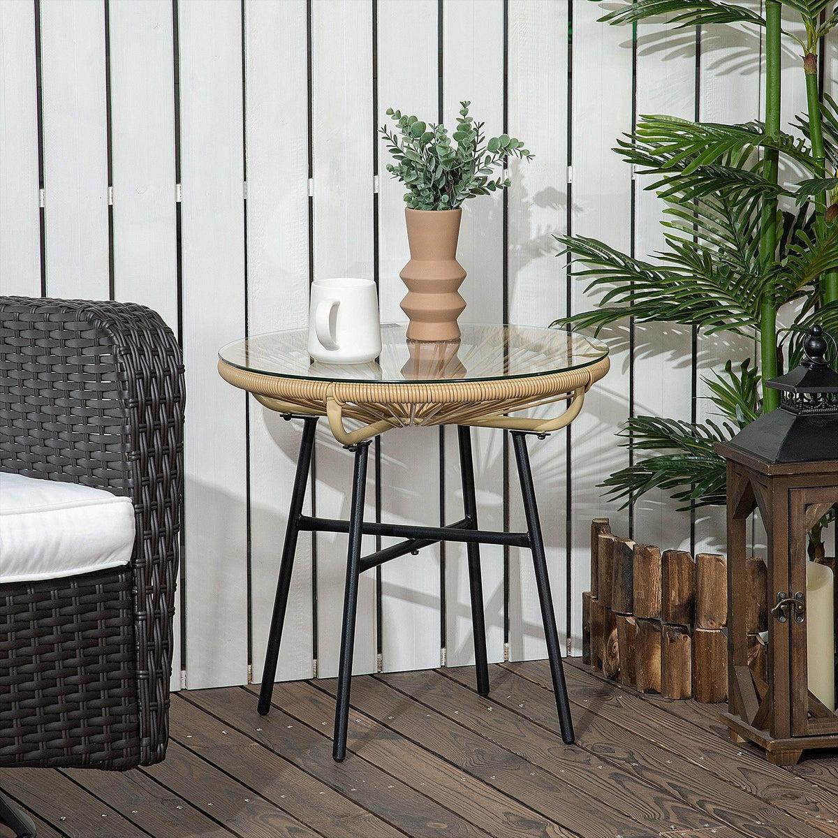 Rattan side table with round tempered glass top and black metal legs