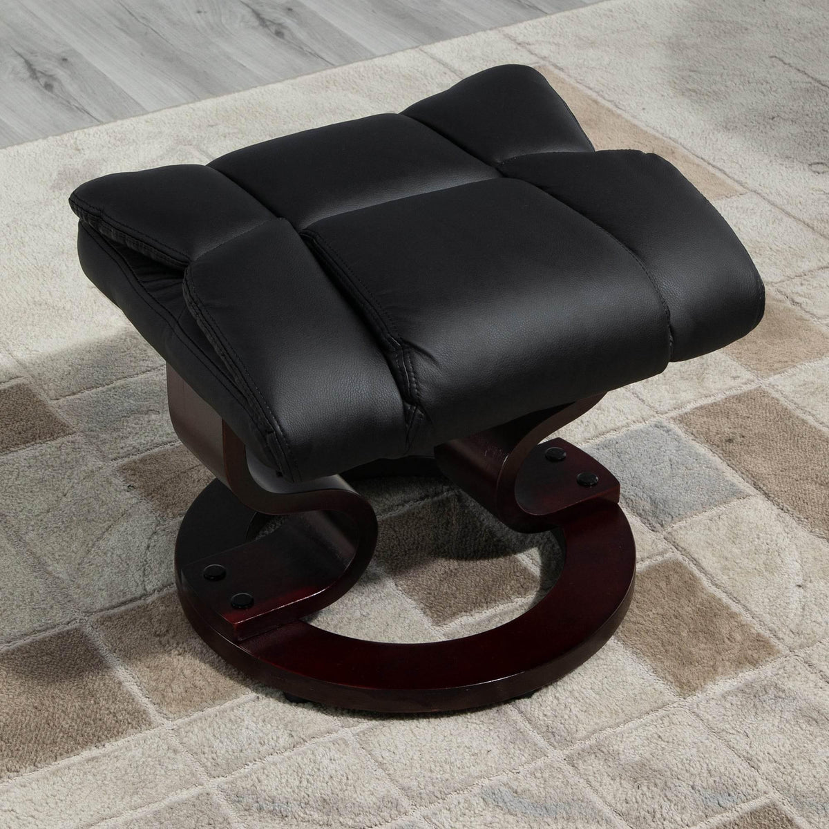 Black padded faux leather ottoman on round swivel base with wood support