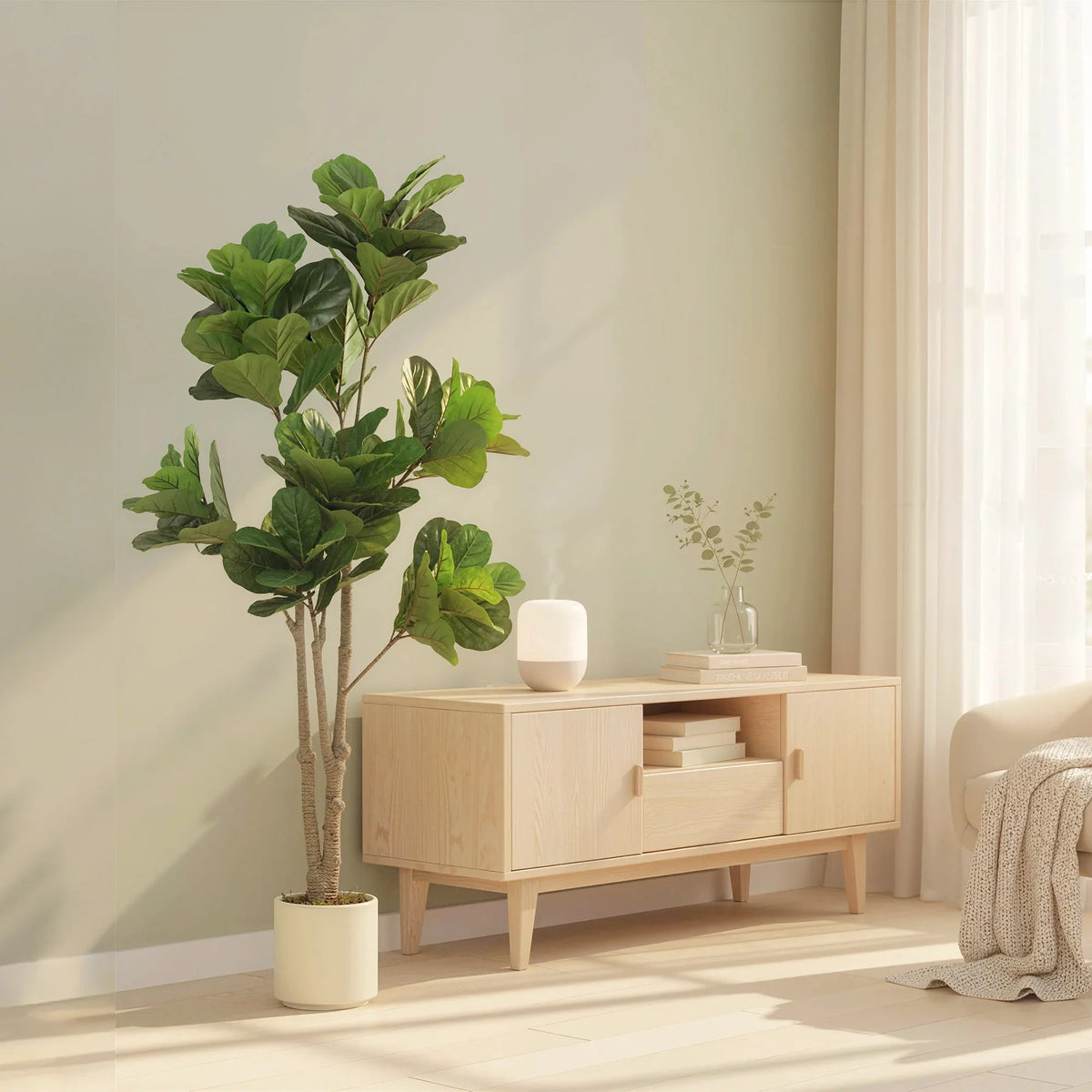 Artificial fiddle-leaf fig tree with green leaves and textured trunk in a white planter pot