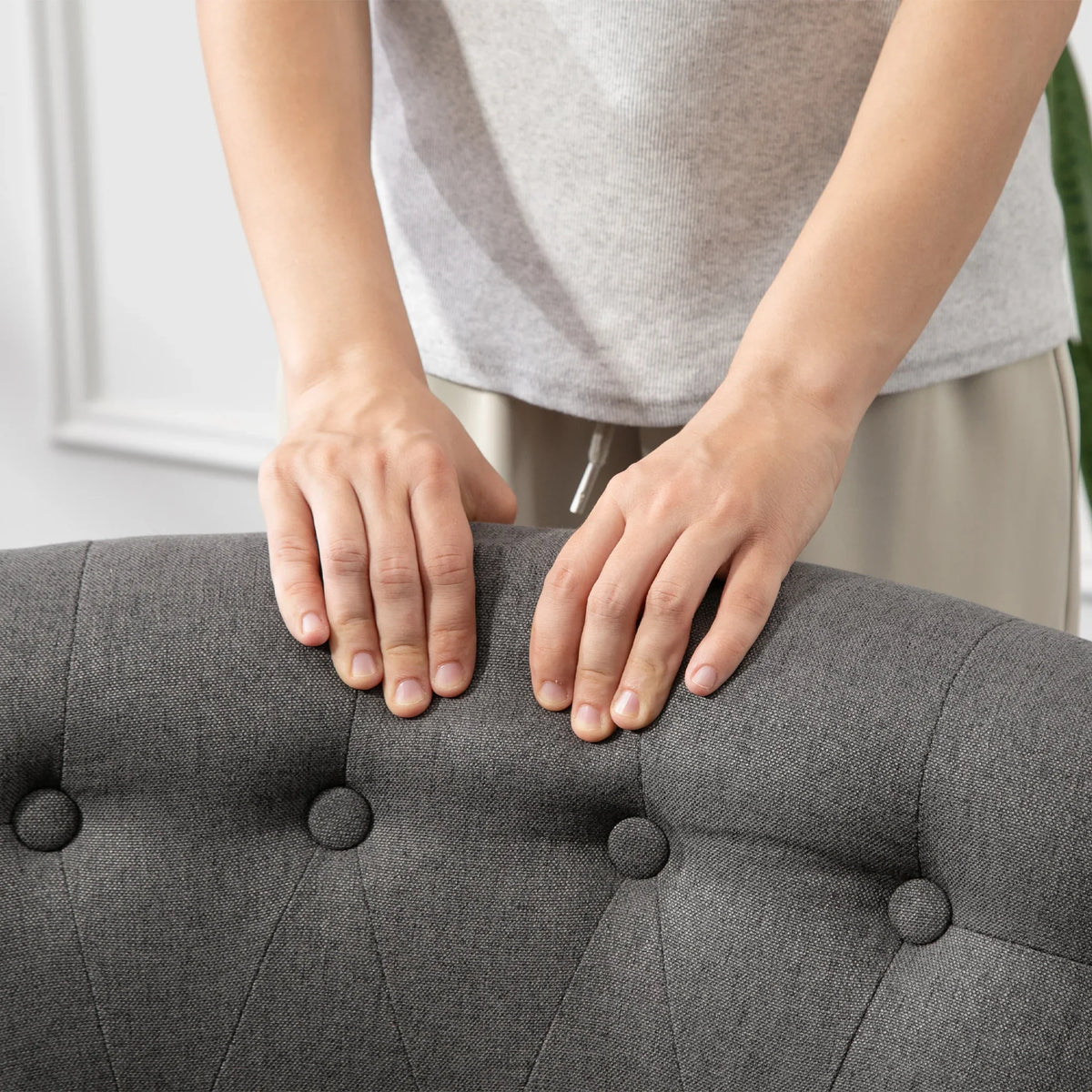 Charcoal grey button-tufted tub chair back and seat with thick padded cushioning