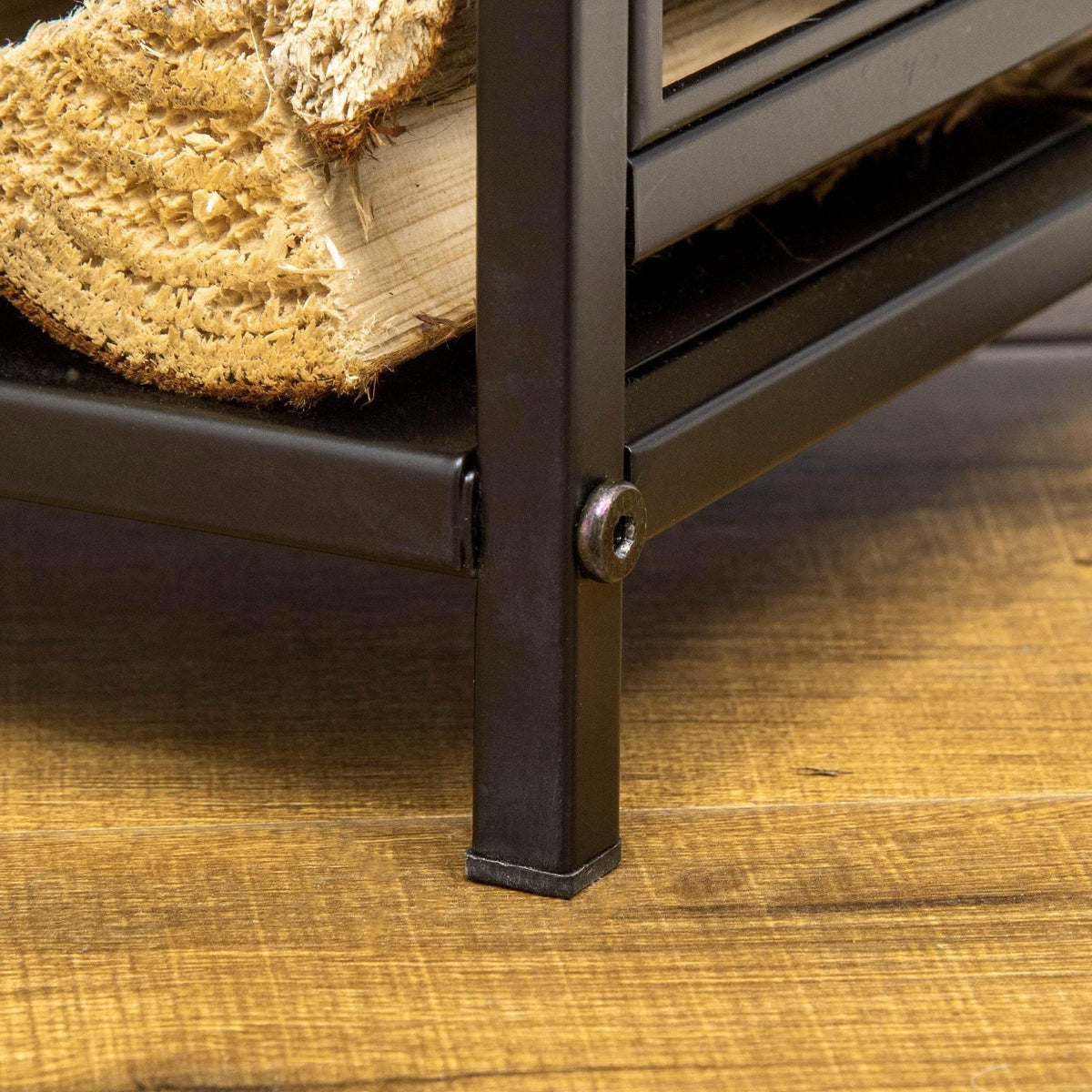 Black steel rack corner leg with bolt detail, holding a woodpile shelf