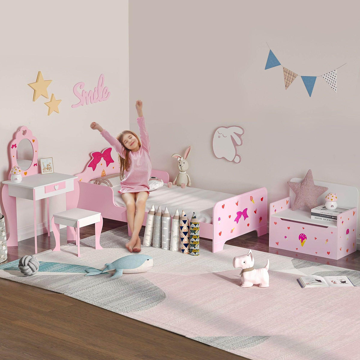 Pink kids bedroom furniture set with low bed, vanity table, and storage bench