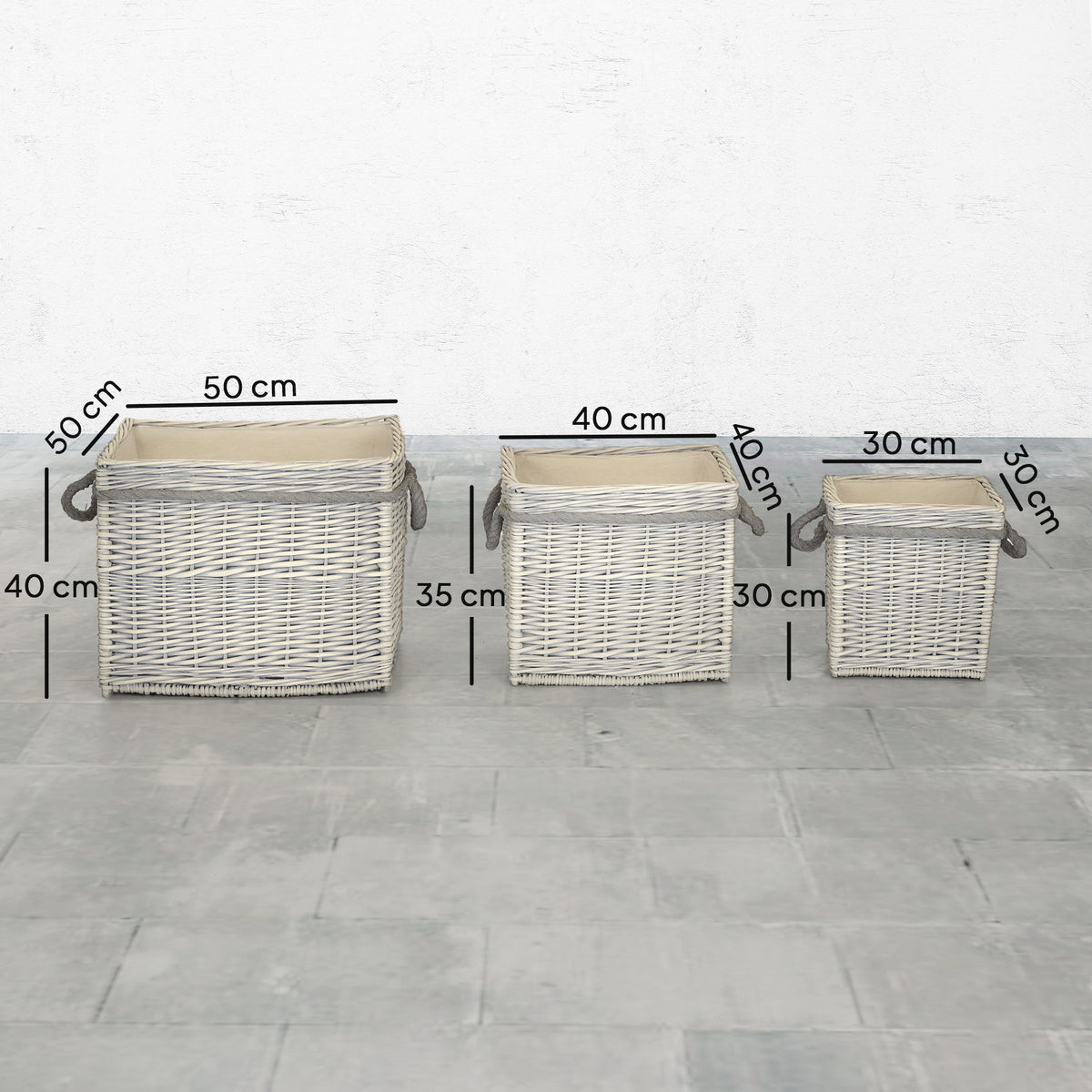 Three light wicker log baskets with rope handles, shown side-by-side with measurements