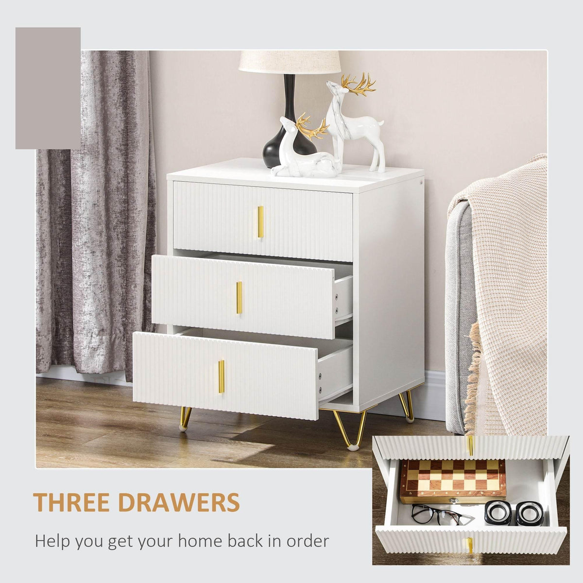 White three-drawer storage unit with gold handles, drawers partly pulled out
