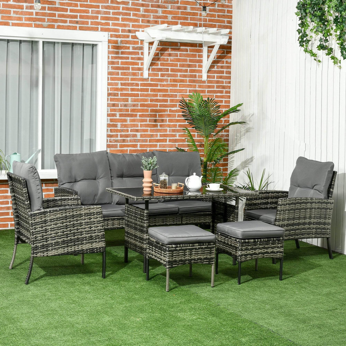 PE rattan outdoor seating set with gray cushions, sofa, two armchairs, and glass table