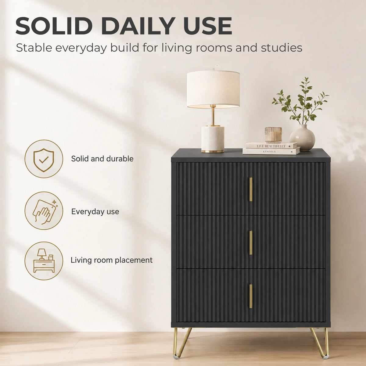Black fluted 3-drawer dresser with gold-tone handles, slim legs, and flat top.