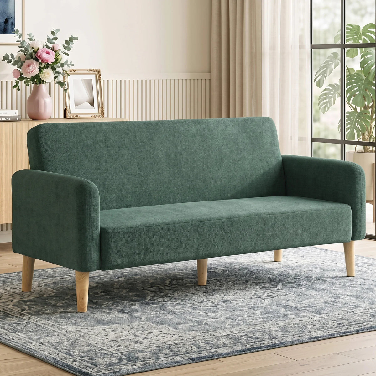 Dark green velvet 2-seater sofa with thick padded cushions and rounded arms