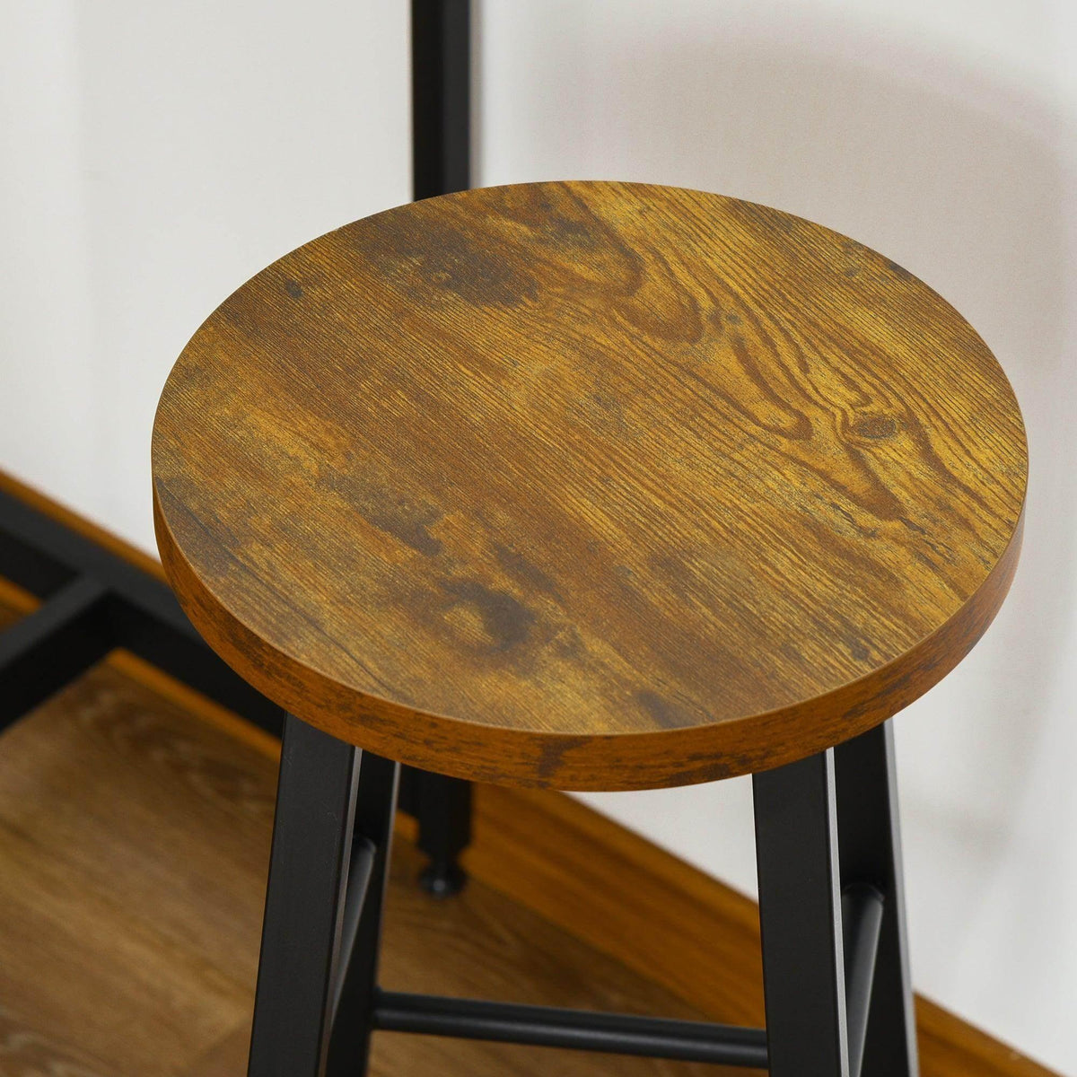 Round upholstered-style bar stool seat with black metal frame and footrest