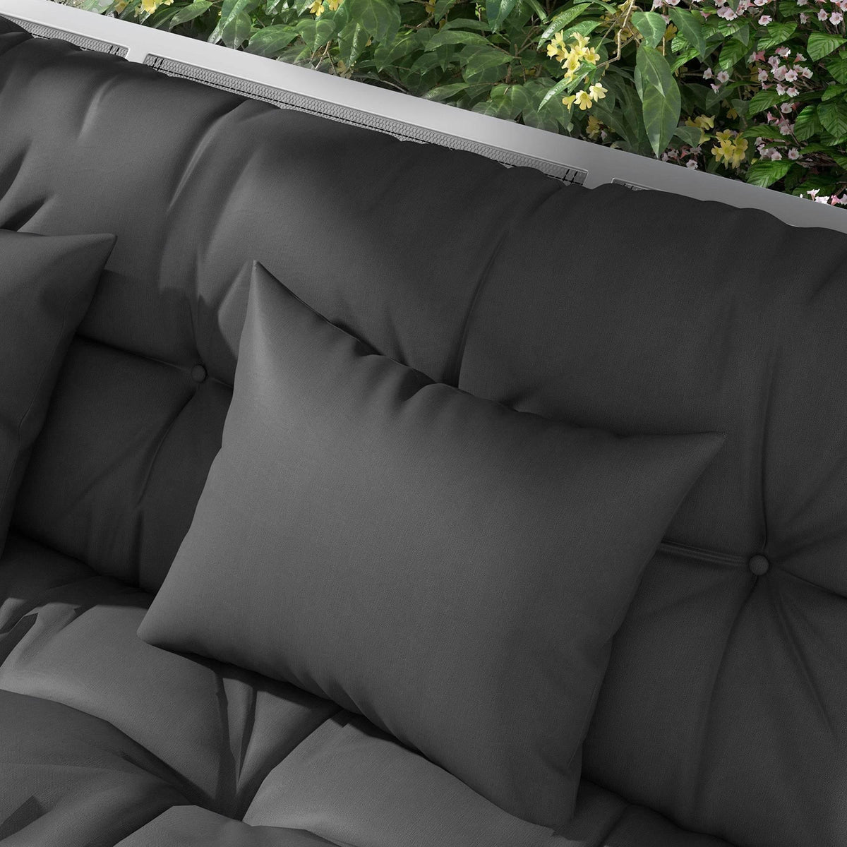 Charcoal grey tufted back cushion with square throw pillow