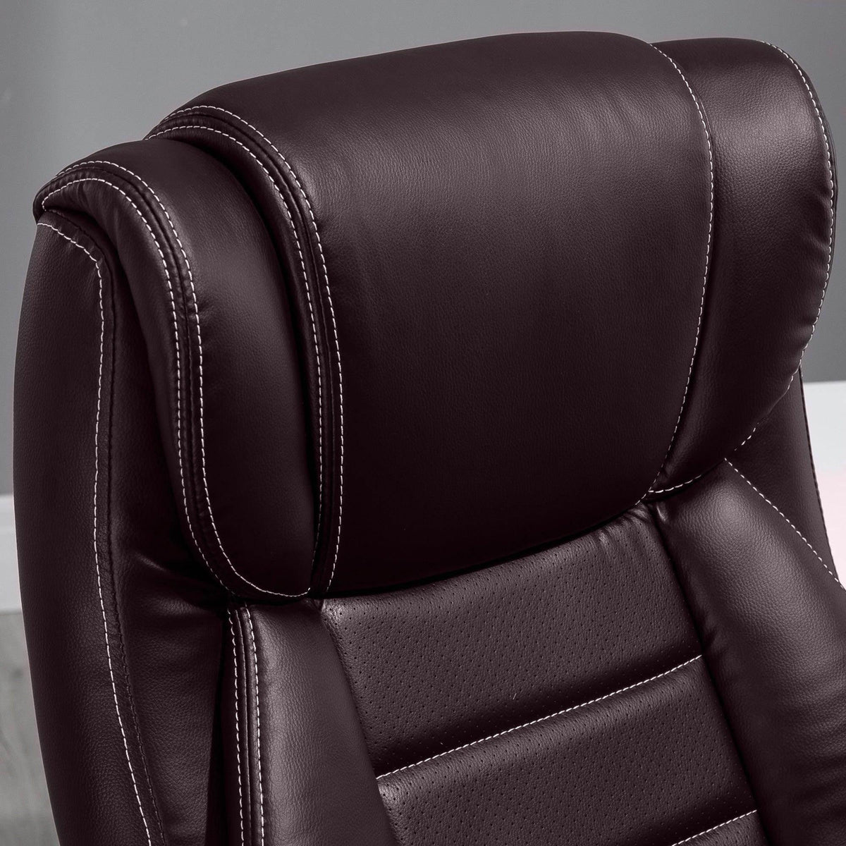 Brown faux-leather office chair back cushion with stitched seams and curved headrest