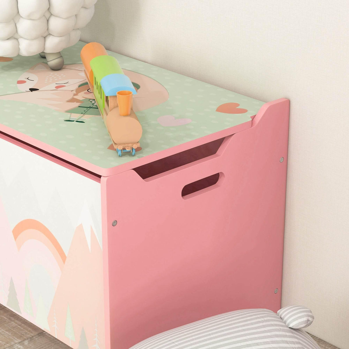 Pink kids toy box with open lid showing interior storage area and front handle cutouts