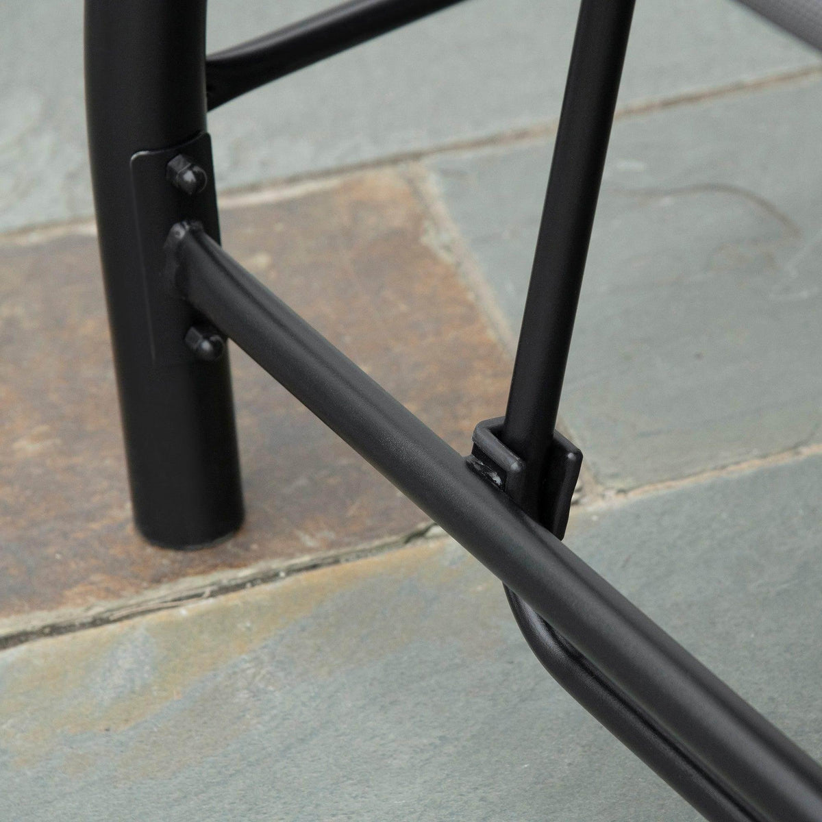 Dark gray swing chair frame corner with sturdy metal base and joints
