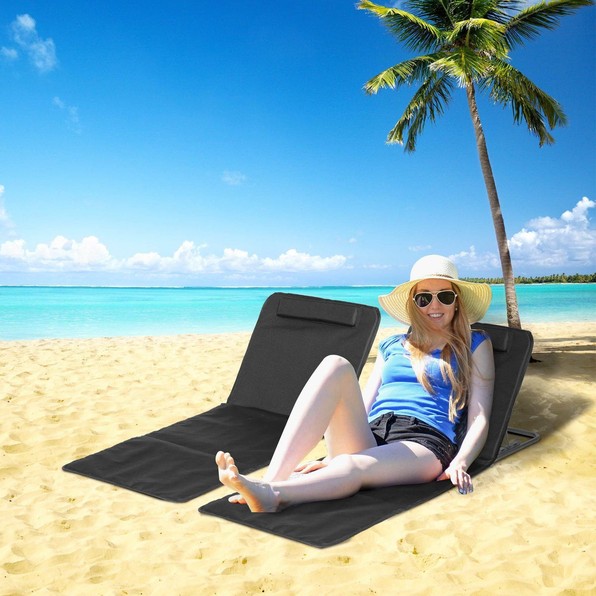 Black outdoor reclining beach chair with attached pillow and padded seat