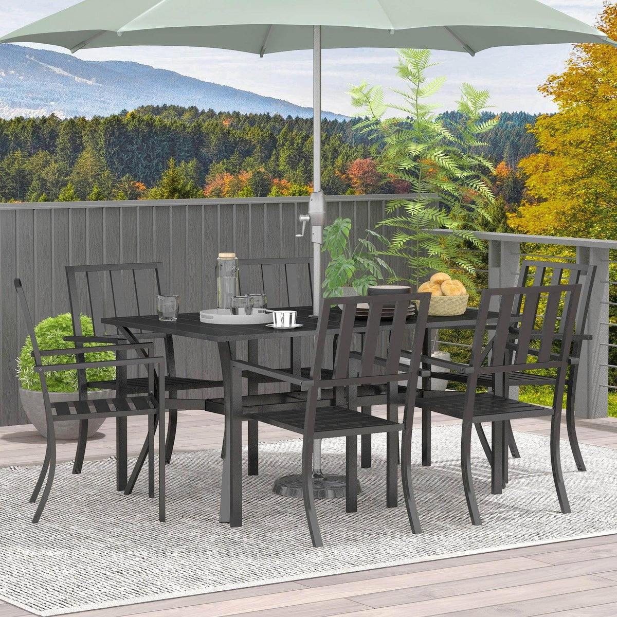 Black outdoor dining table and six chairs set with umbrella hole, arranged on patio.