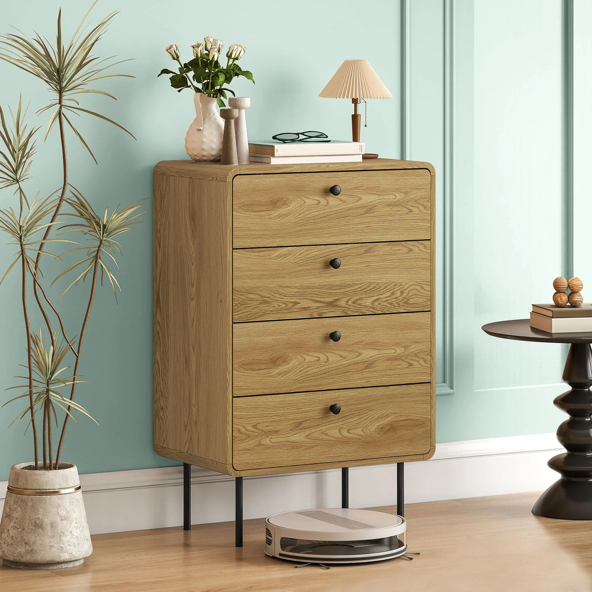Oak 4-drawer chest with smooth drawer fronts, black knob handles, and tapered legs.