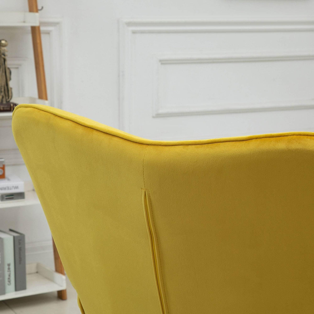 Yellow velvet wingback armrest and curved seat cushion with vertical seam detail