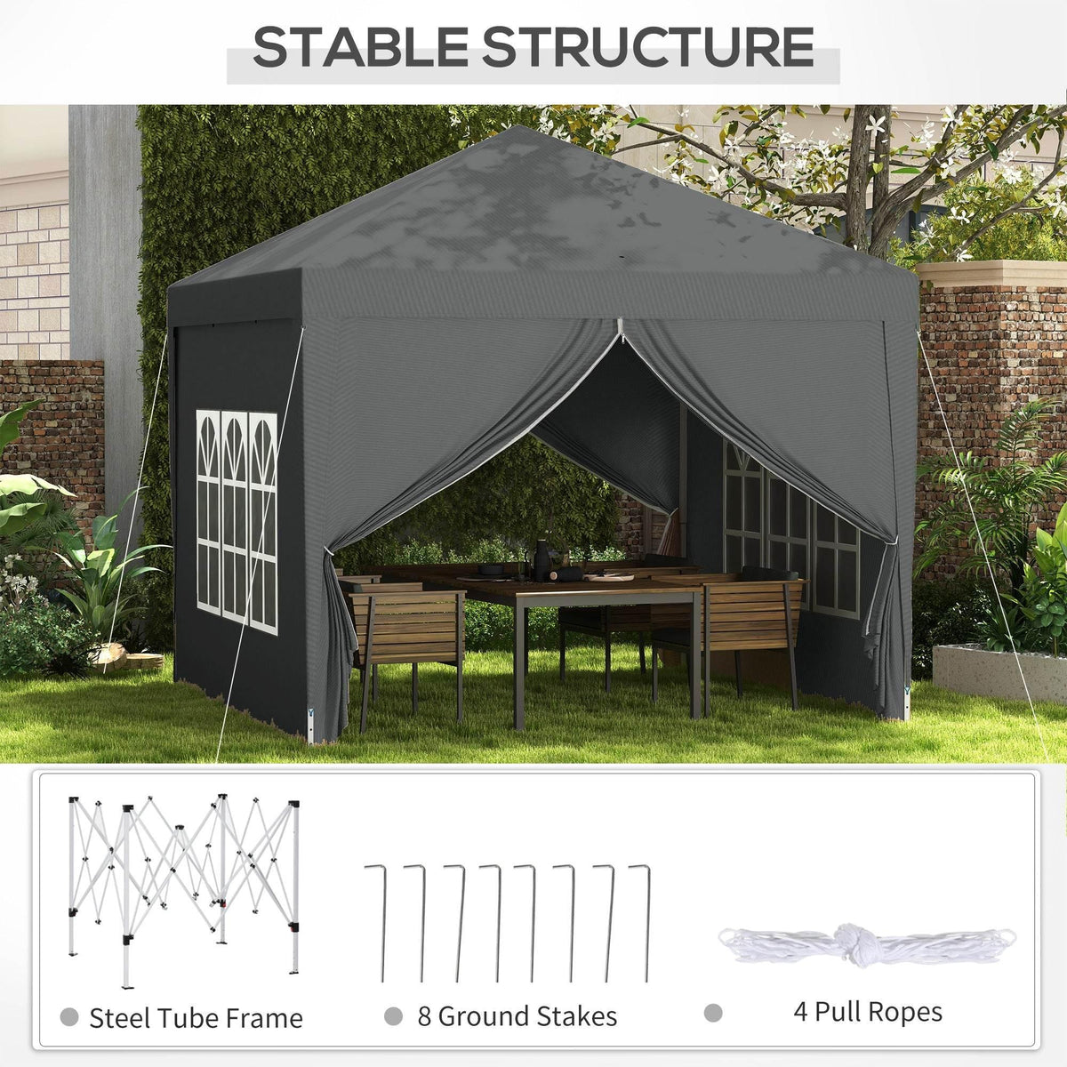 Grey pop-up canopy tent with arched window panels and peaked roof, set up in backyard