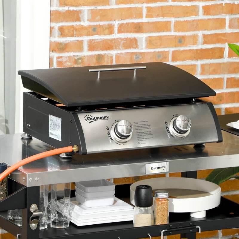 Portable tabletop gas plancha grill with non-stick black griddle and two stainless knobs