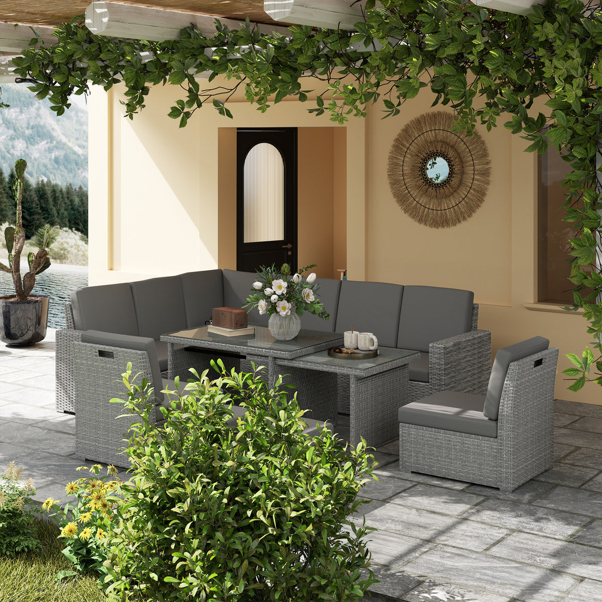 Grey rattan garden sofa set with expanding table and corner seating on outdoor patio