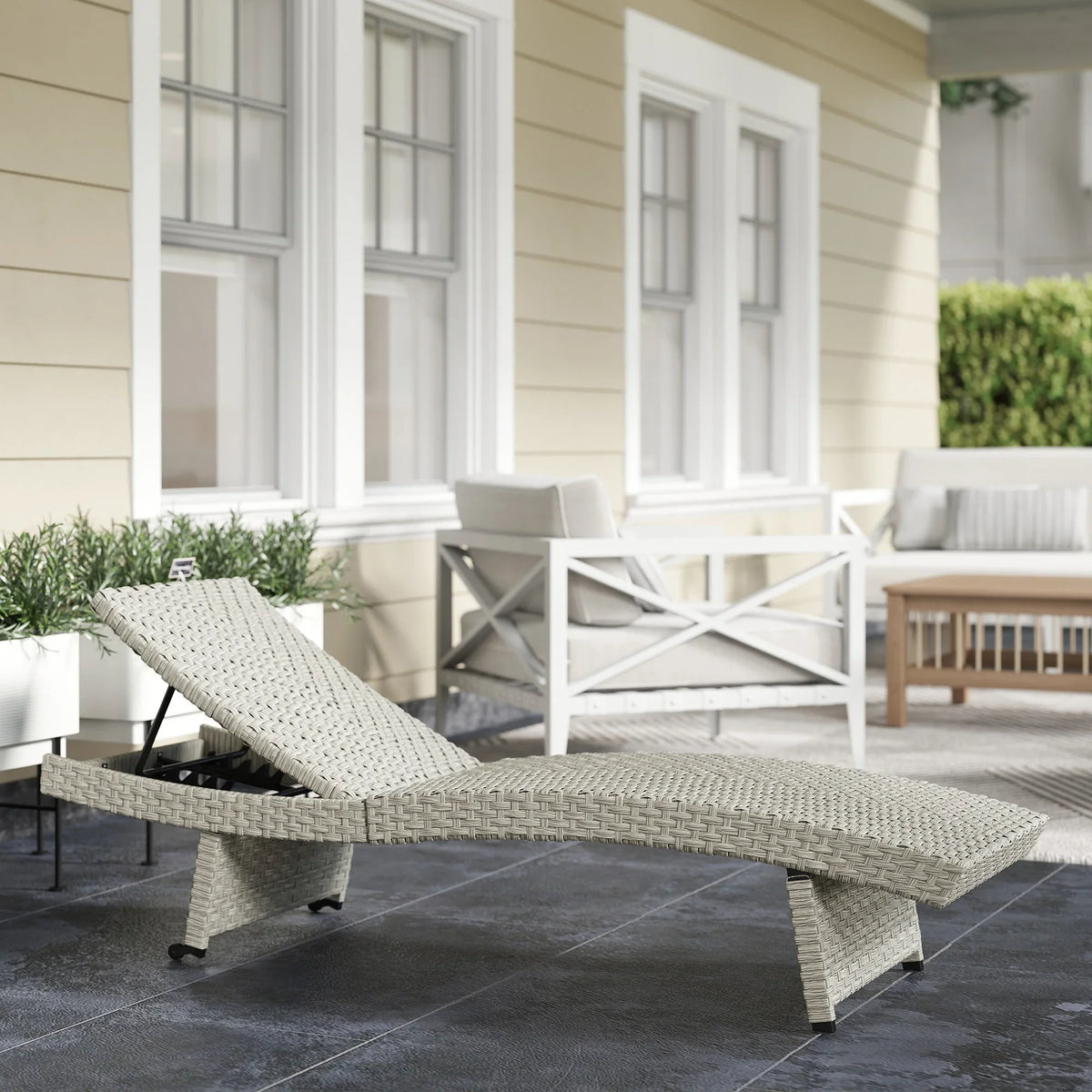 Grey woven outdoor sun lounger with folding frame, adjustable backrest, and wheels