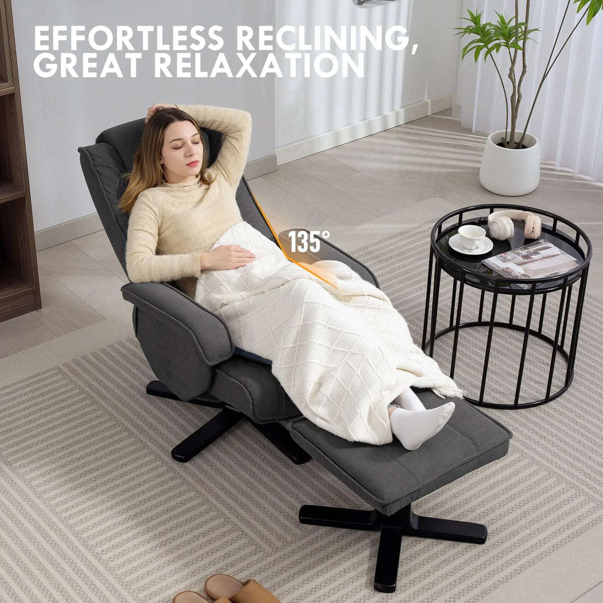 Charcoal grey velvet swivel recliner chair with footstool reclined at 135°