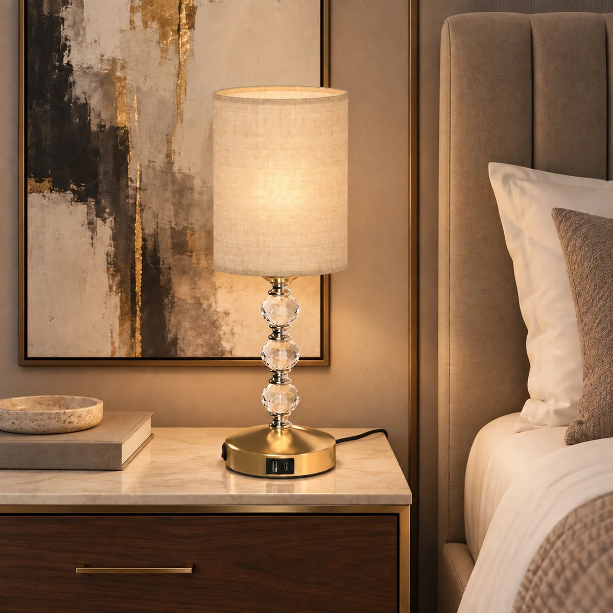 Crystal bedside table lamp with beige fabric shade and clear glass crystal column