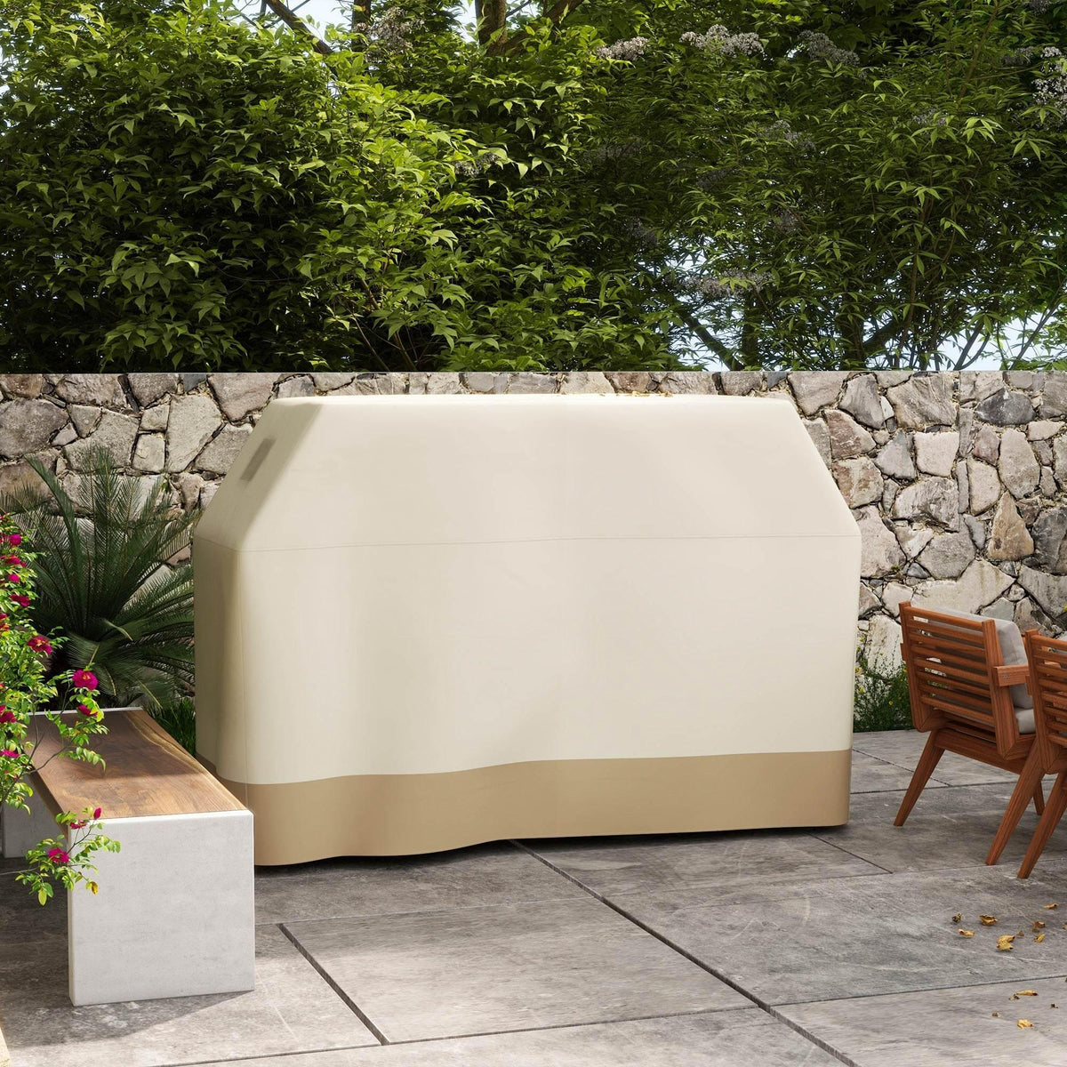 Beige waterproof BBQ grill cover with tan side panel, draped over grill on patio