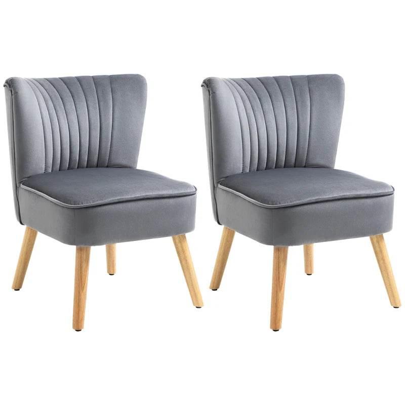 Pair of grey velvet accent chairs with channel-tufted curved backs and wood legs