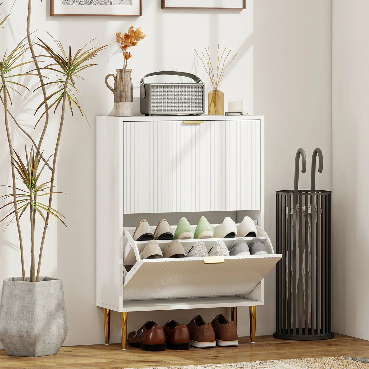 White two-door shoe cabinet with ridged doors, gold accents, open flip shelves