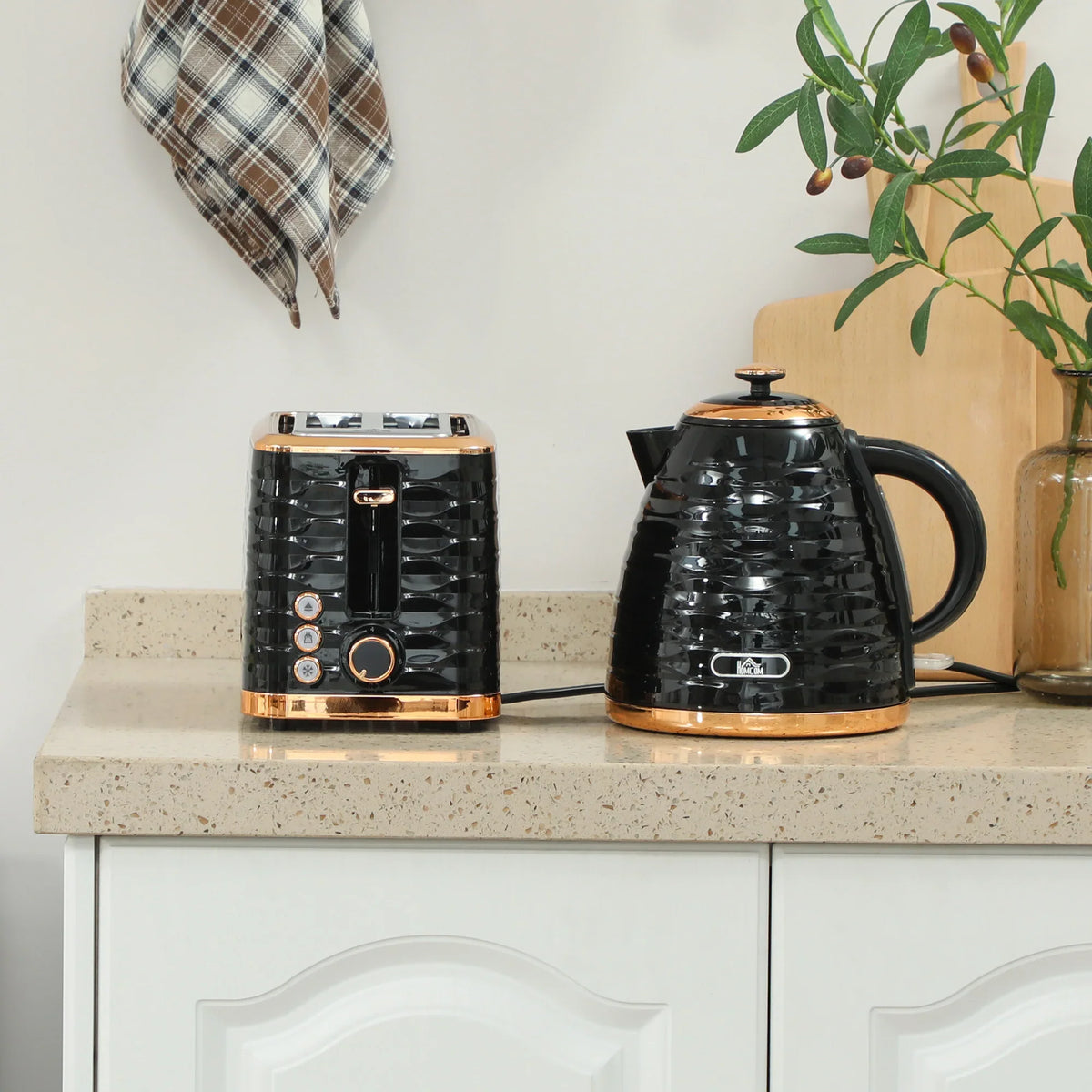 Black electric kettle and 2-slice toaster set with rose-gold trim on countertop