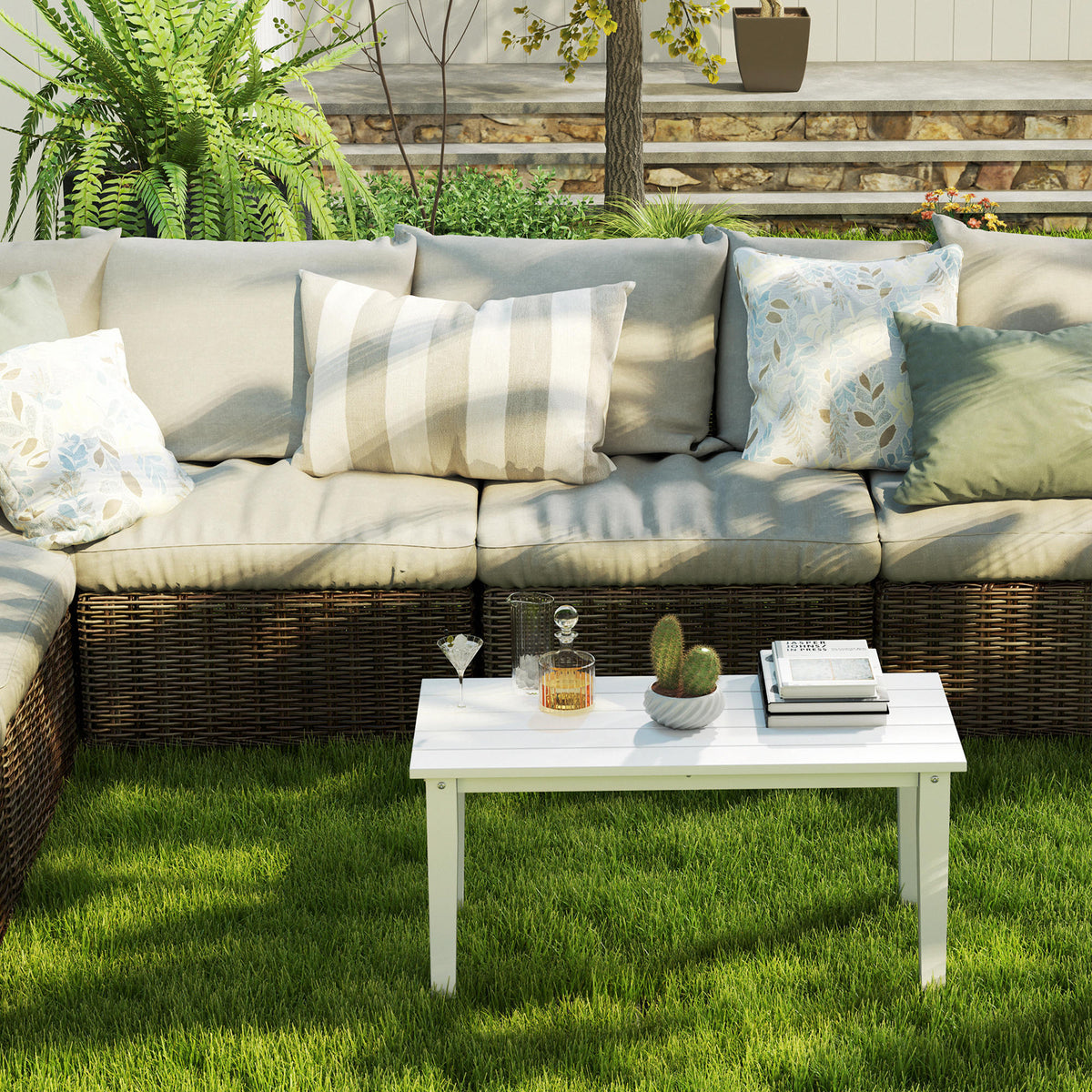 White rectangular coffee table with slatted top and four straight legs beside outdoor sofa