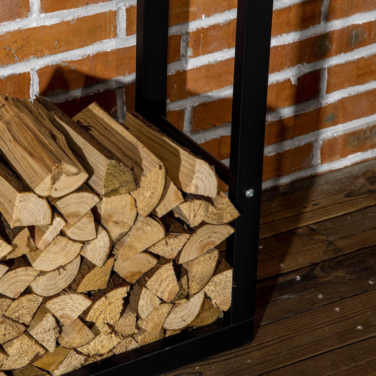 Black metal firewood rack corner view with firewood logs stacked inside