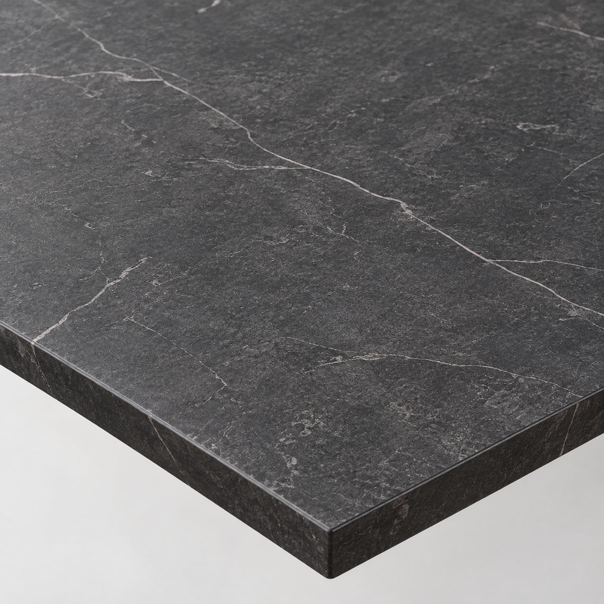 Black marble-finish tabletop with dark veining and beveled edge