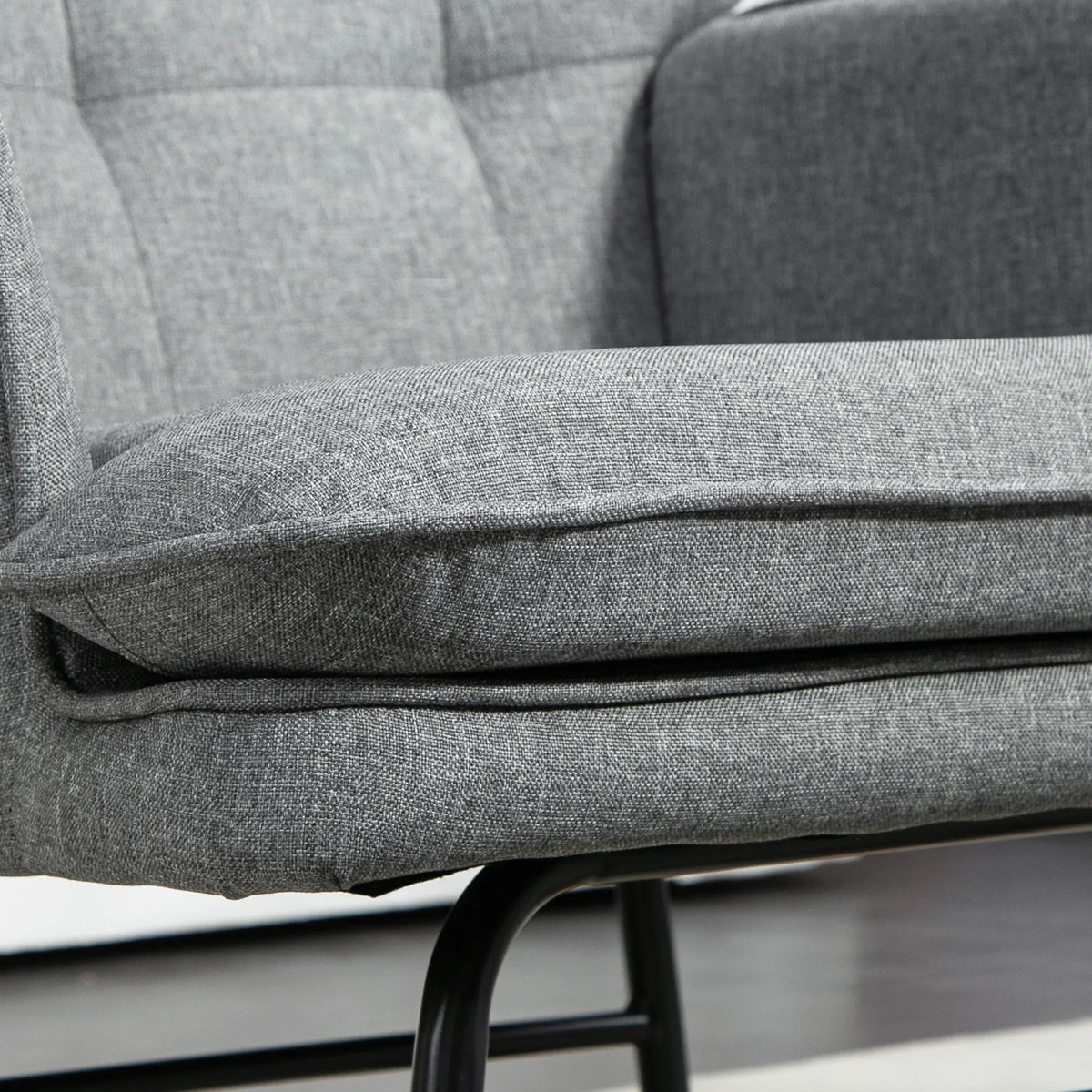 Grey padded seat and arm detail on rocking chair with coordinating ottoman cushion