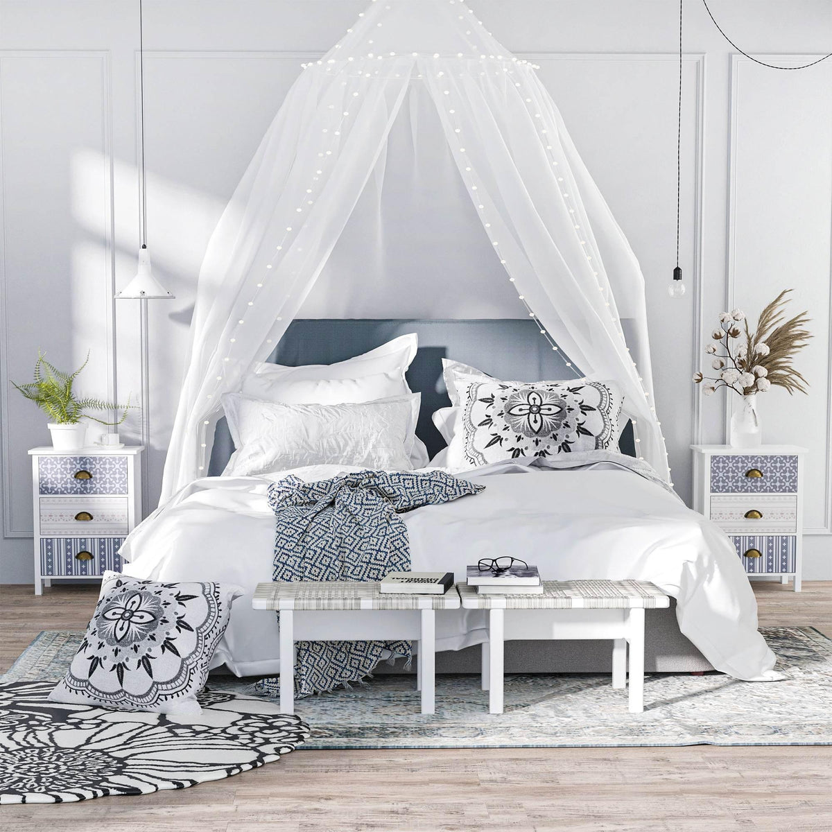 White nightstand set with patterned drawers and antique brass cup pulls beside bed