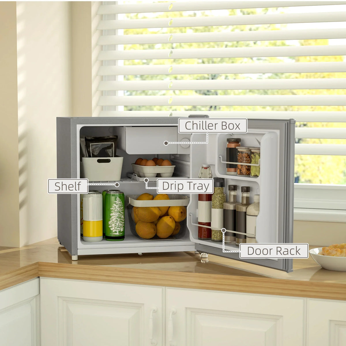 Lockable mini fridge open door showing chiller box, shelves, drip tray, and door rack.