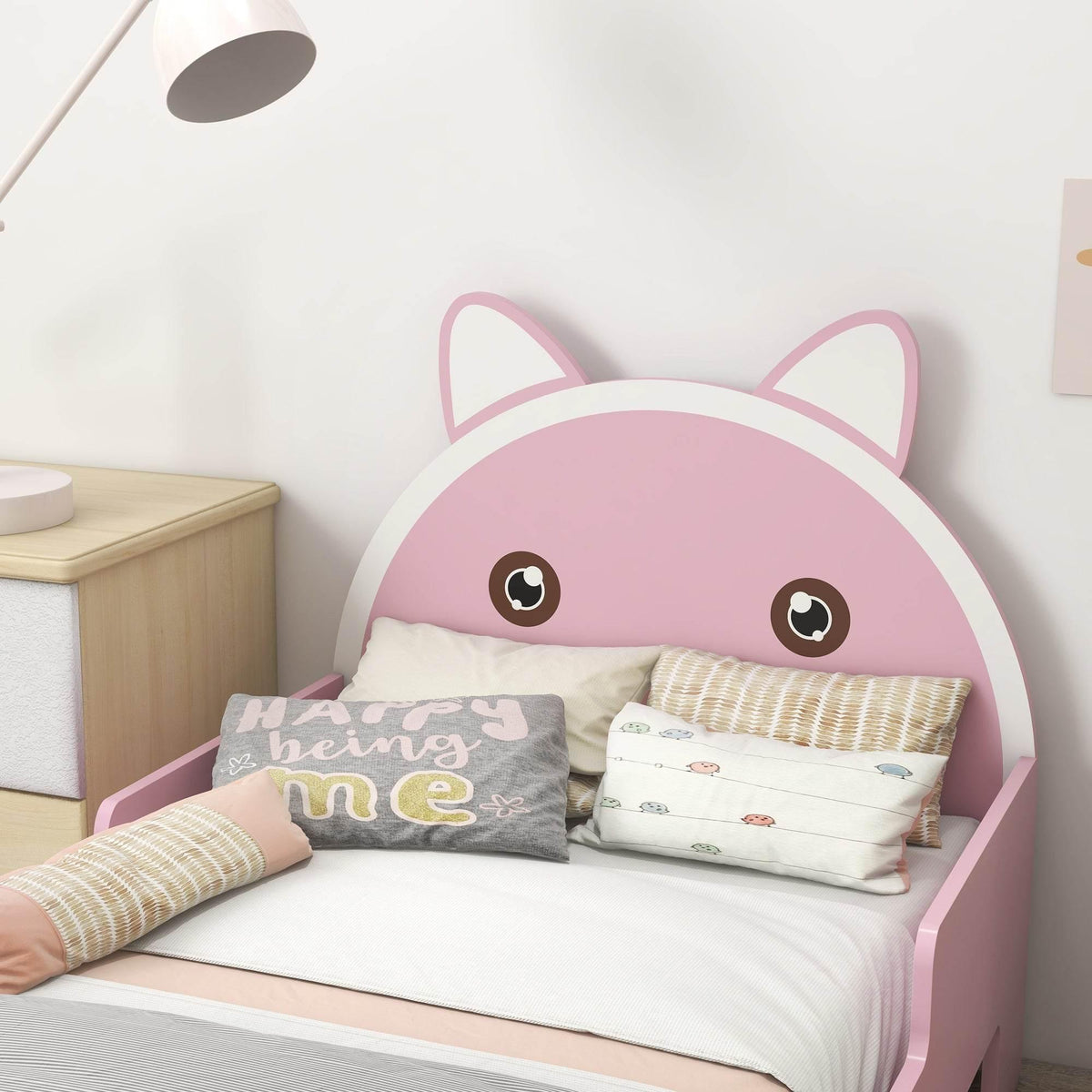 Cat-faced pink wooden kids bed with pillows and printed blanket
