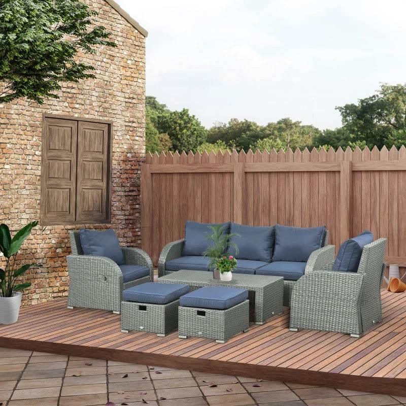 Outdoor rattan dining set with blue reclining armchairs and square ottoman table