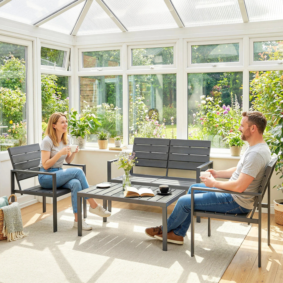 Indoor conservatory-style setup: dark grey slatted armchairs and coffee table set